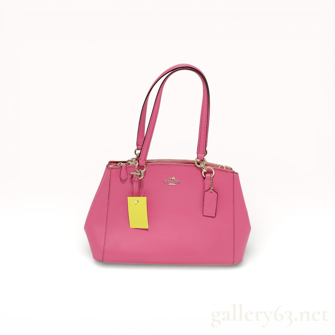 Coach 36637 Leather 2-Way Shoulder Bag in Pink with Top Handles and Removable Strap: Authentic Coach leather shoulder bag having a structured trapezoidal silhouette in pink leather. Design featuring dual rolled top handles and a detachable adjustable shoulder strap allowing hand or sh