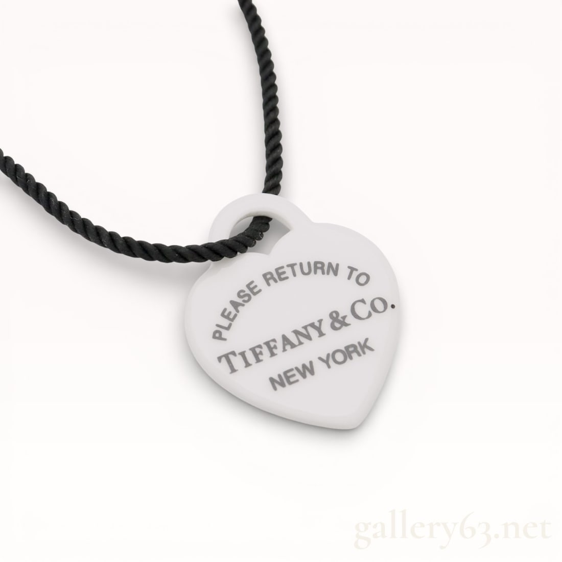 Tiffany&Co. Return to Tiffany Heart Tag Plastic Pendant 16 inch Necklace: Authentic Tiffany&Co. black twisted cord and a heart-shaped white plastic pendant. Pendant featuring printed text reading “Please Return To TIFFANY & CO. New York” arranged across the