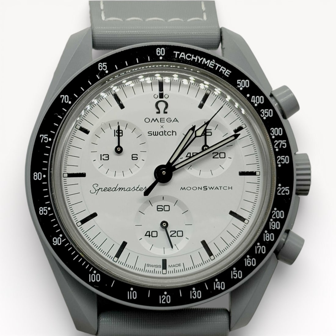 Brand New OMEGA x Swatch MoonSwatch Speedmaster Chronograph Watch with Light Dial and Fabric Strap,: Authentic OMEGA x Swatch MoonSwatch Speedmaster chronograph watch with a light-colored dial featuring luminous baton hour markers, three subsidiary registers, and contrasting chronograph hands. Round
