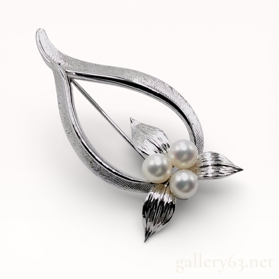 Mikimoto Akoya Pearl Diameter Approx. 5.2mm 925 Sterling Silver: Brooch by Mikimoto, with three Akoya pearls, each having diameter approximately 5.2 mm. Sterling Silver mount marked .925, set with pearls in a clustered arrangement. Total weight approximately 7.0 g.