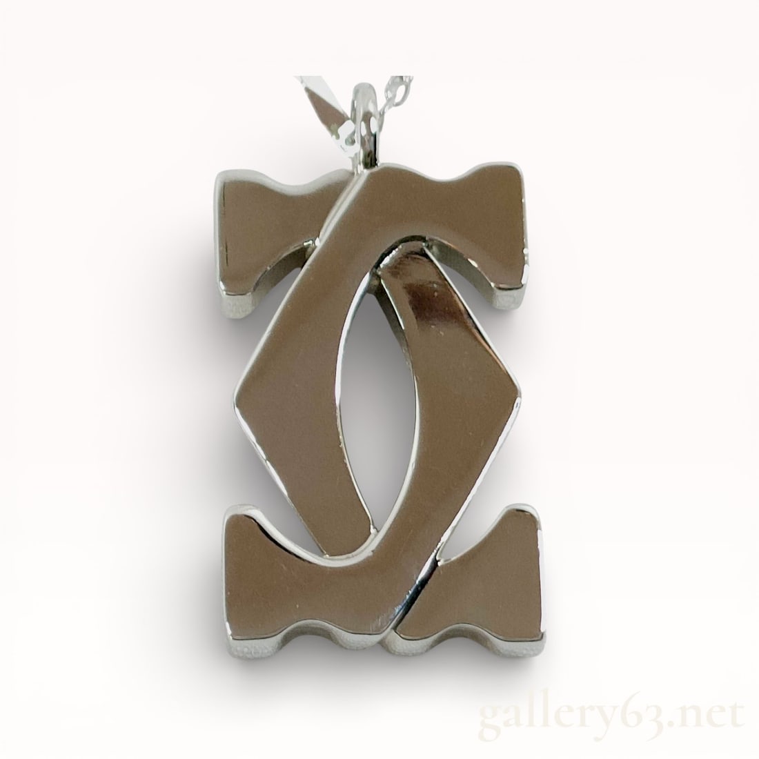 Cartier 2C logo charm pendant Silver 20.5 inch Necklace: Authentic Cartier Necklace. Fine silver chain and a pendant of interlocking double-C form rendered in polished white metal. Design featuring a dimensional logo motif with layered construction and smoo
