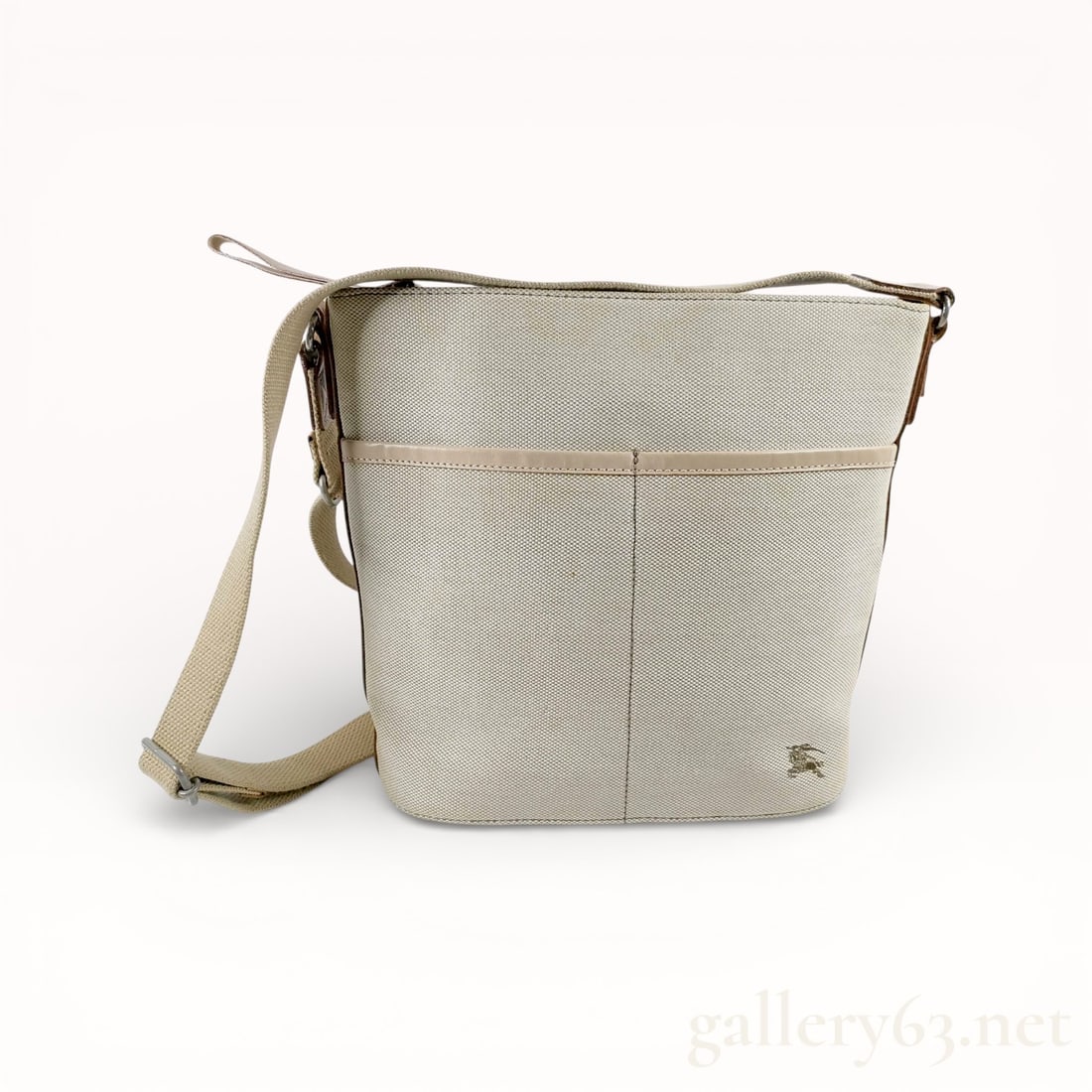 Burberry Blue Label Burberry Canvas Shoulder Bag: Authentic Burberry shoulder bag having a rectangular shape and single shoulder strap. Constructed in canvas fabric featuring a check pattern in muted tones. Trimmed with leather along edges and strap.