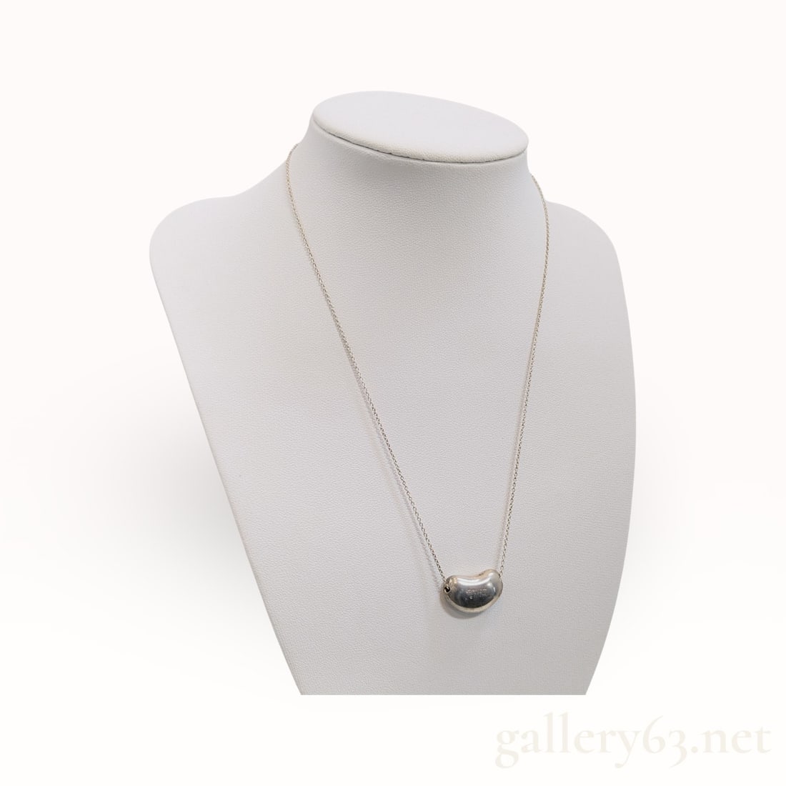 Tiffany&Co. Bean .925 Sterling Silver Necklace: Authentic Tiffany&Co. fine silver chain and a small bean-form pendant with a smooth domed surface. Design featuring an organic rounded silhouette with high-polish finish. Construction including a