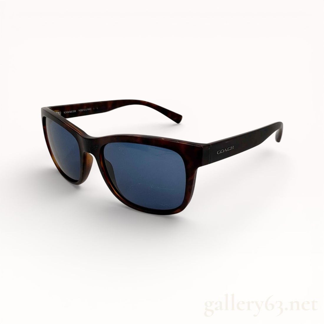 Coach Square Tortoise Sunglasses With Case: Authentic pair of square-frame design sunglasses in a mottled brown tortoise-patterned material, having dark tinted lenses set within thick rims. Construction featuring integrated nose rests and artic