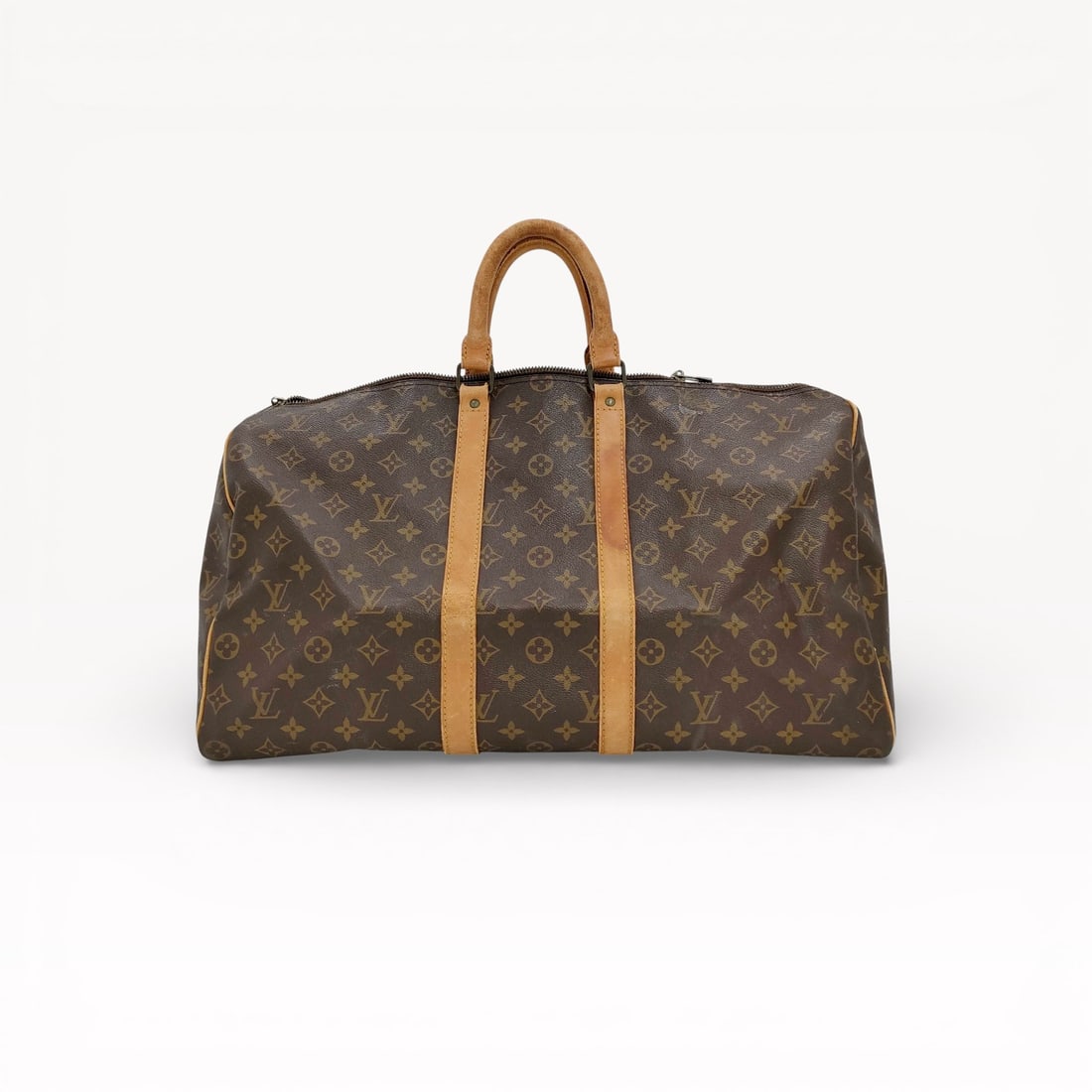 Louis Vuitton Keepall 50 Travel Bag in Monogram Canvas with Vachetta Leather Trim: \Authentic Louis Vuitton Keepall 50 travel bag in Monogram coated canvas with natural vachetta leather trim. Rectangular duffle silhouette featuring dual rolled leather top handles, reinforced leather