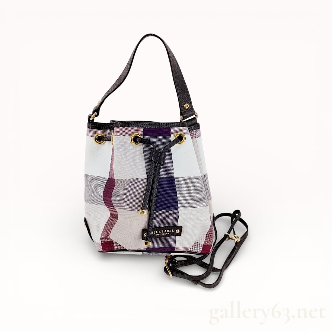 Burberry Blue Label Crestbridge 2-way Drawstring Shoulder Bag: Authentic Burberry bag having a rectangular body, this Burberry Blue Label Crestbridge shoulder bag features a 2-way drawstring closure. Constructed from coated canvas, the exterior includes a smooth