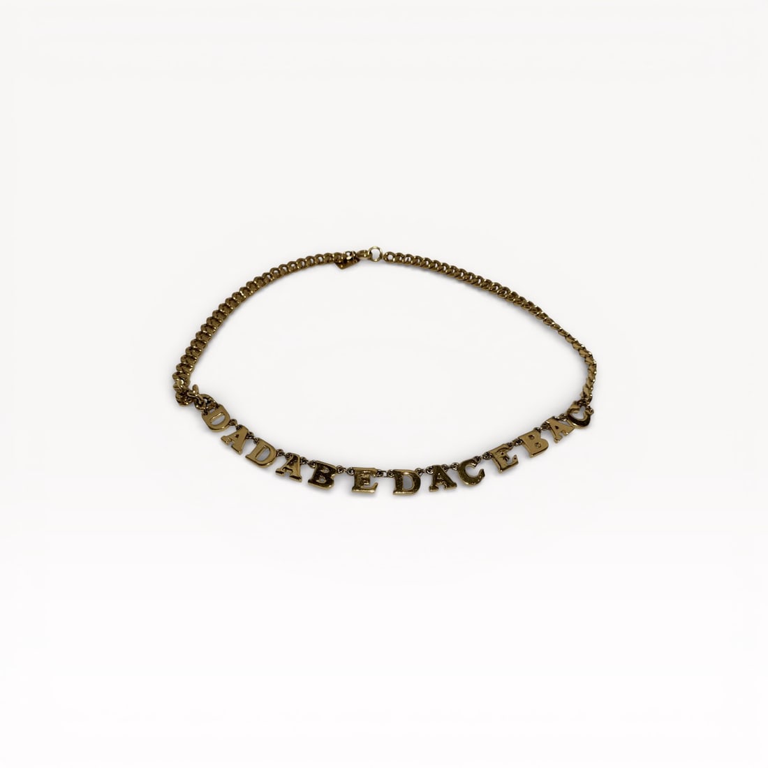 Kenzo Gold-Tone Chain Necklace with Alphabet Letter Charms: Authentic Kenzo necklace in gold-tone metal. Medium-weight chain fitted with a series of individual alphabet letter charms forming a linear motif across the front. Lobster clasp closure at back, marki