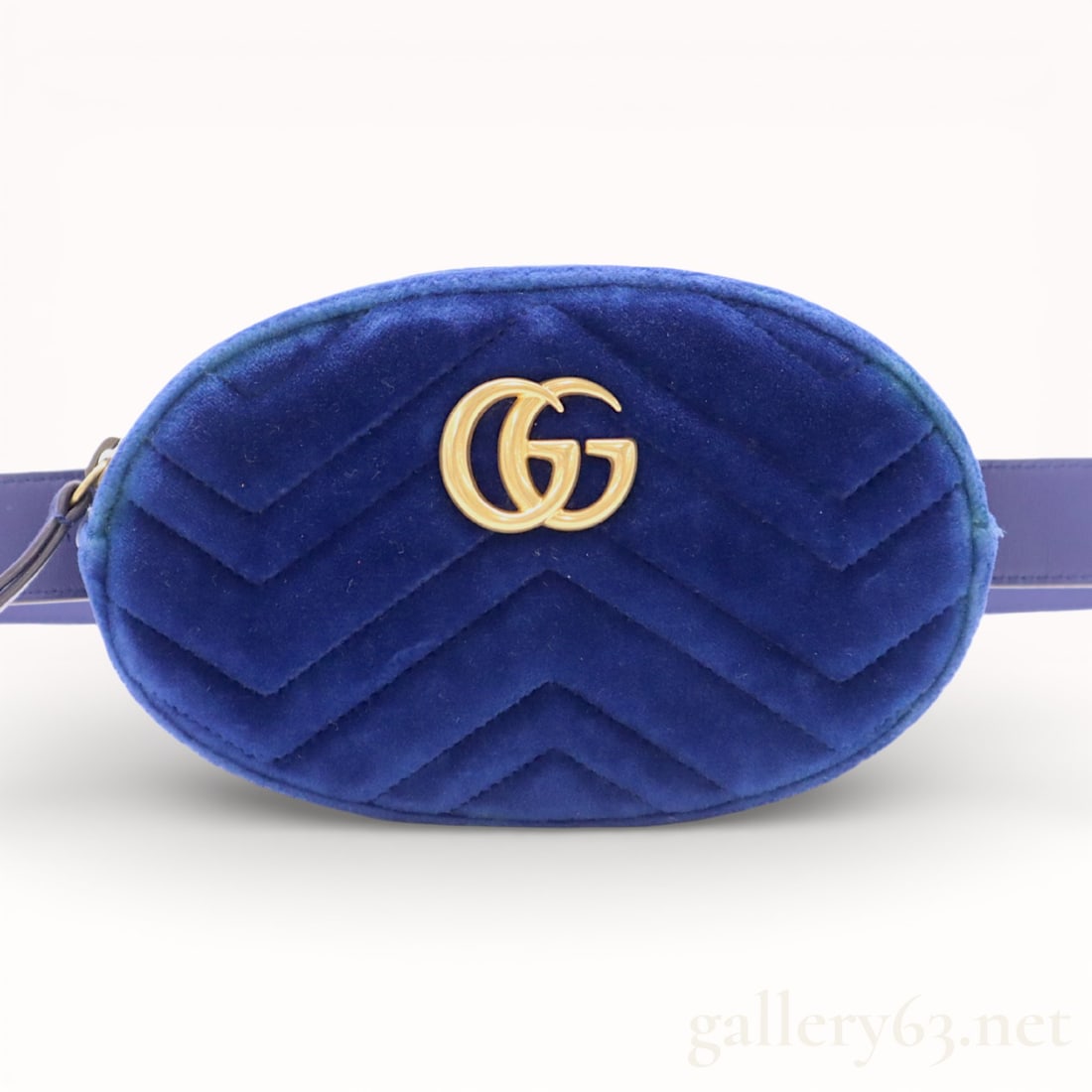 Gucci GG Marmont Blue Waist Bag: Authentic Gucci blue waist bag, having a chevron-quilted exterior, set with a metal GG logo on the front flap, and featuring a zippered main compartment. Adjustable strap with buckle closure.