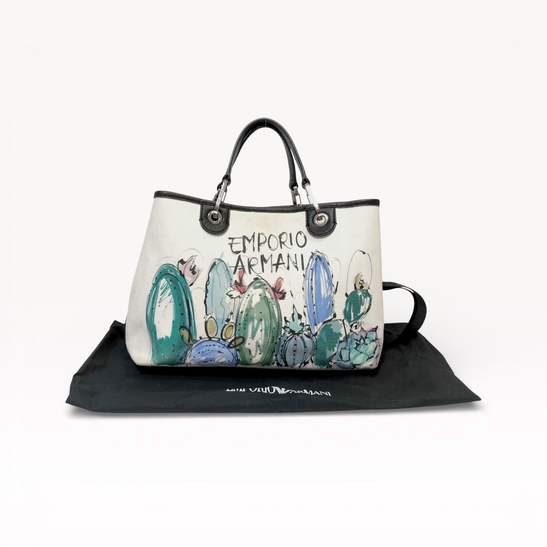 Emporio Armani 2-Way Canvas Tote Bag with Graphic Print: Authentic Emporio Armani 2-way tote bag crafted in durable canvas with a bold, artistic graphic design across the front. This versatile bag can be carried by the structured top handles or worn crossbo