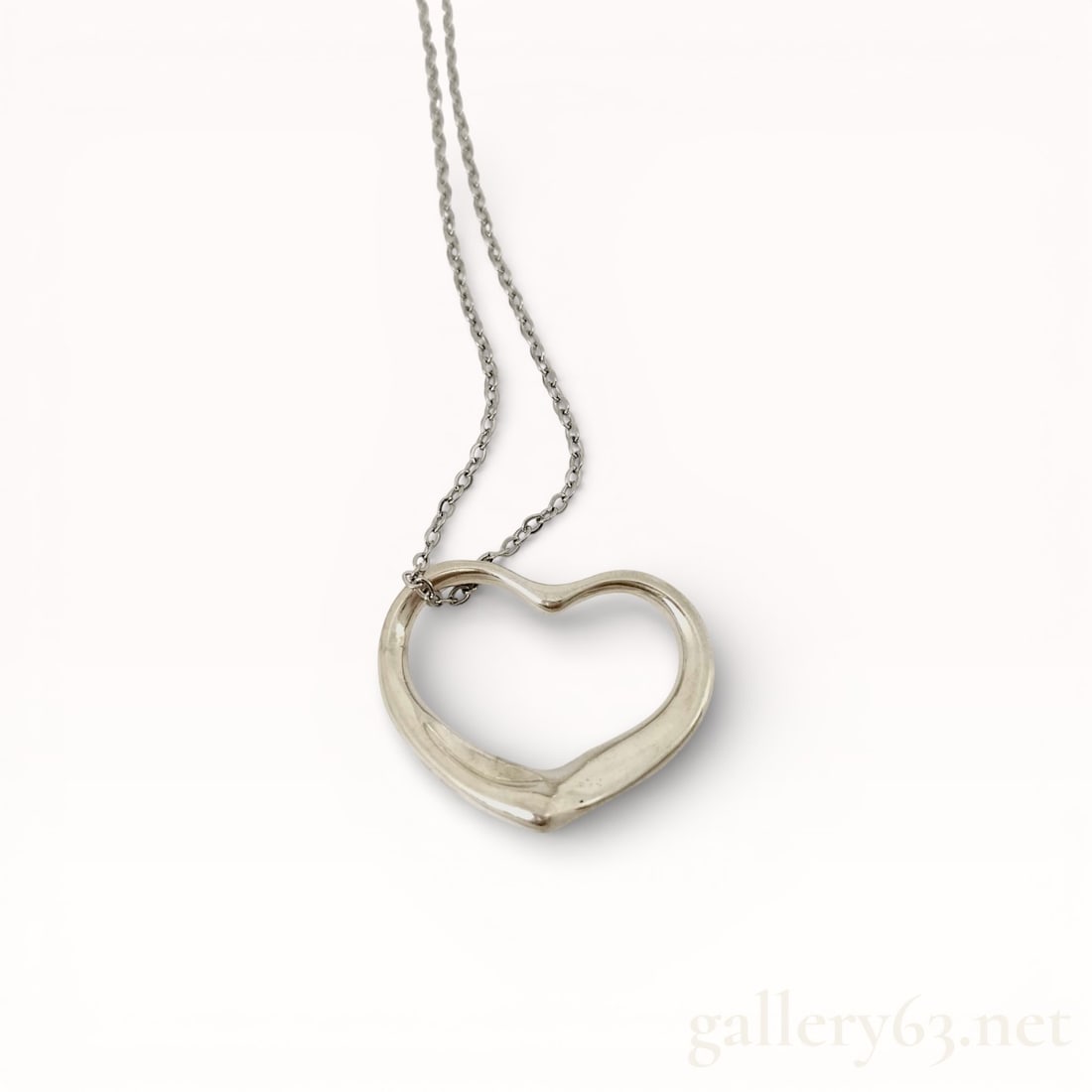 Tiffany&Co. Open Heart 20.5 inch Necklace: Authentic Tiffany&Co. .925 silver chain and an open heart-form pendant with a smooth polished surface. Design featuring a continuous heart outline with gently rounded contours and a tapered lower