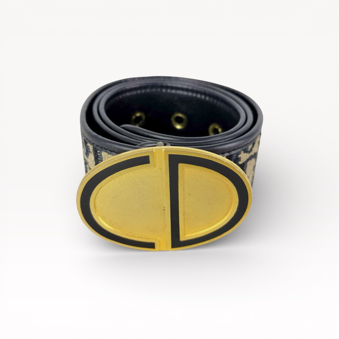 Christian Dior Trotter Canvas Belt with Gold-Tone CD Buckle size 65: Authentic Christian Dior belt in navy Trotter canvas with leather backing. Adjustable strap finished with a large oval CD logo buckle in gold-tone metal with black enamel detailing. Punched sizing hol