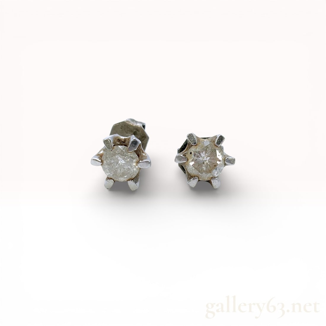 Diamond Solitaire Studs in Platinum: Diamond Solitaire Studs in Platinum. Platinum 900 stud earrings holding round brilliant diamonds in 6-claw prong settings. Fitted with butterfly catch backs also in platinum 900. 1.3 grams total. Ligh