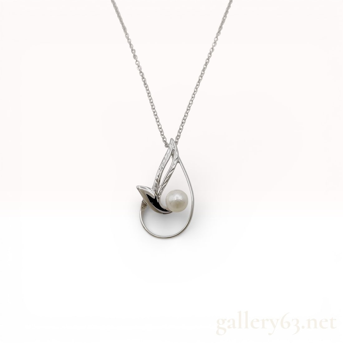 Mikimoto Sterling Silver Abstract Teardrop 5.4mm Pearl Pendant Necklace: Mikimoto Sterling silver necklace featuring an abstract teardrop-form pendant accented with a single round cultured pearl. Sculptural openwork design combining polished silver curves with minimalist M