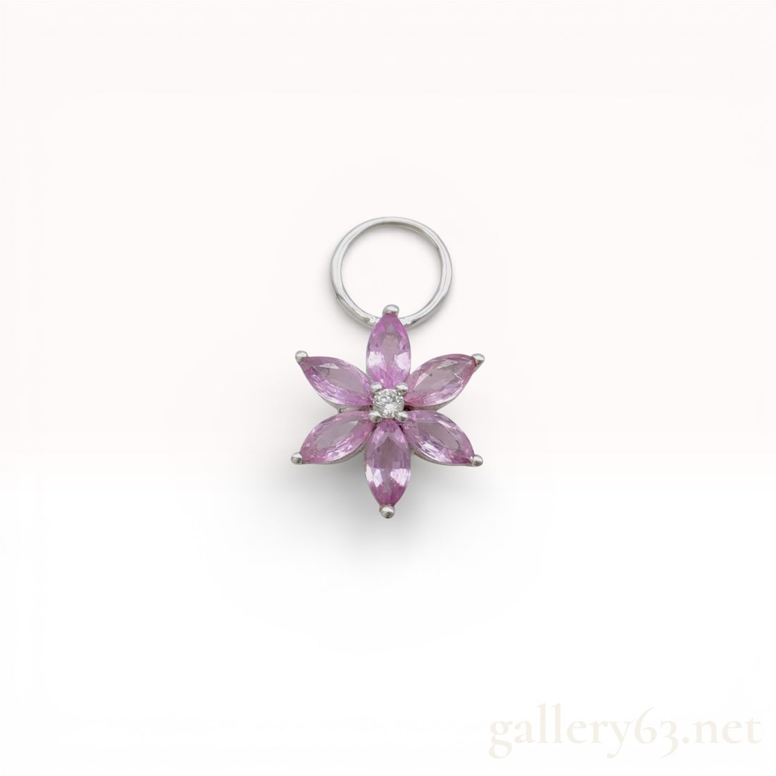 18k White Gold .60ct Pink Sapphire Floral Pendant Top with Diamond Accent: 18k White Gold Pendant featuring a floral motif formed by marquise-cut pink sapphires arranged as petals. Center displays a small round diamond accent adding subtle sparkle. Crafted in 18k white gold