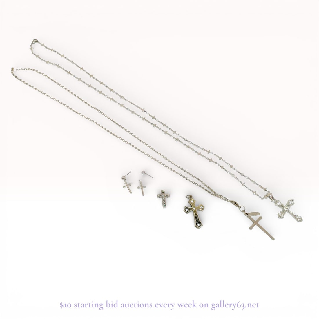 Cross Necklaces, Pendants, and Earrings, Group of 5: Group of five cross-themed jewelry pieces including necklaces, pendants, and earrings, executed in silver finishes. The assortment includes chain necklaces with cross pendants in varied sizes and styl