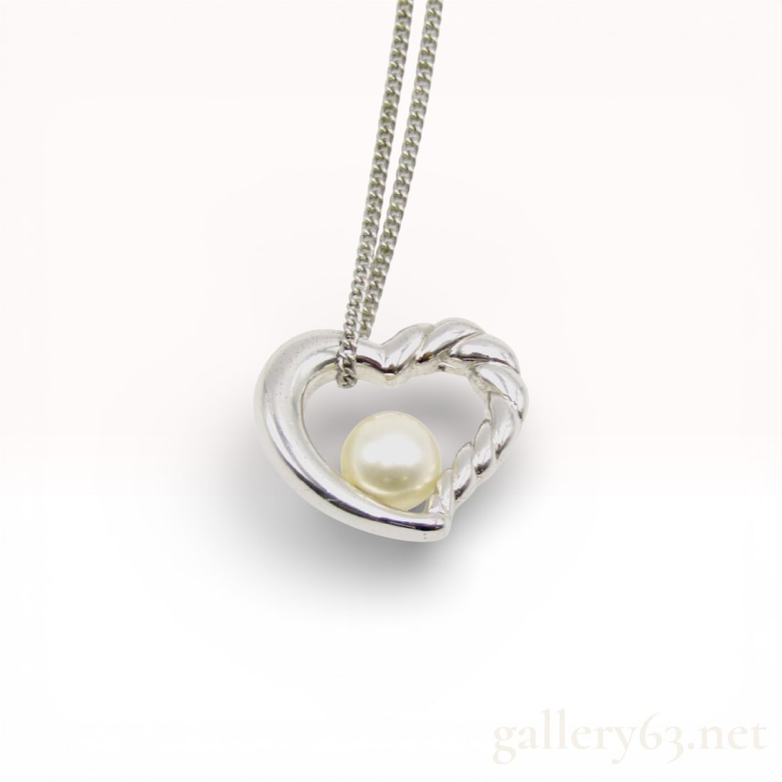 TASAKI Sterling Silver Heart Pendant Cultured Pearl Necklace, Approx. 6.9mm: Sterling silver TASAKI necklace featuring a heart-shaped pendant design accented by a cultured pearl measuring approximately 6.9mm in diameter. Pendant presents a softly sculpted open heart motif with
