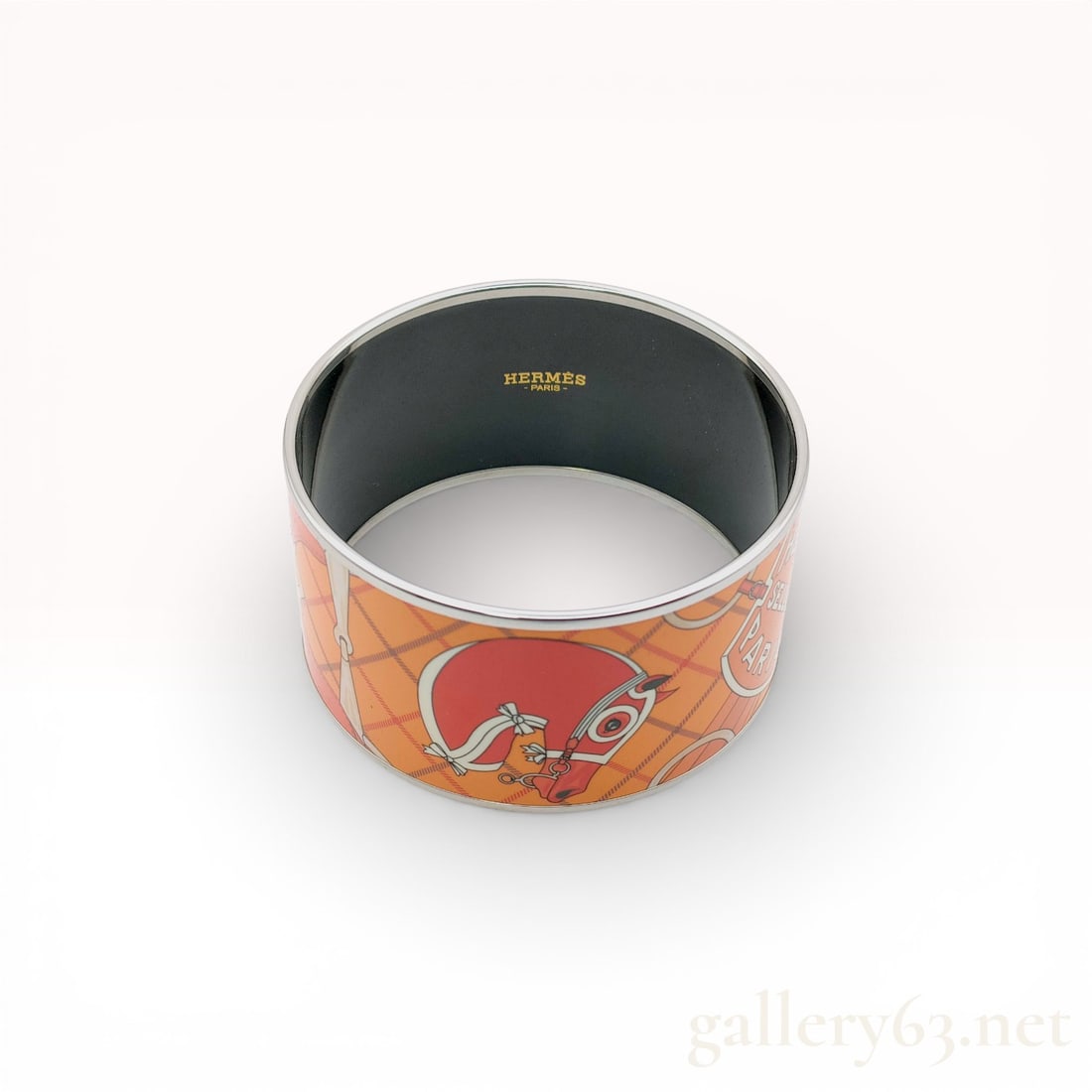Hermès Orange Enamel Printed Wide Bangle Bracelet Gold Plated with Box & Pouch, 7": Hermès bangle bracelet featuring orange enamel construction with an equestrian-inspired printed motif. Wide silhouette accented by polished metal edging and contrasting interior finish. Bra