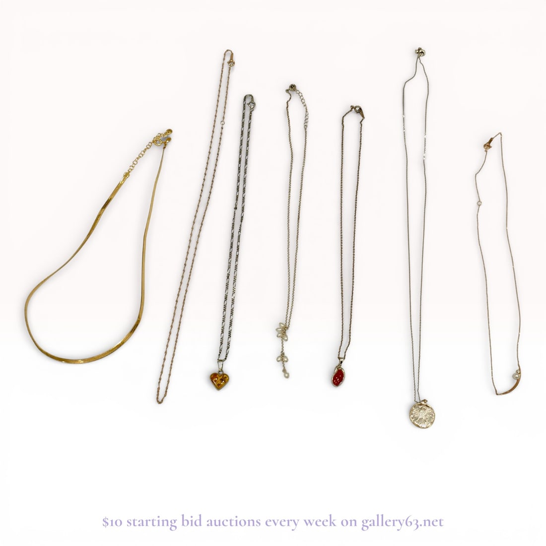 Silver-Tone and Gold-Tone Necklaces, Mixed Chain Styles, Group of 7: Group of seven necklaces executed in silver and gold metal, featuring varied chain styles and lengths. The assortment includes simple snake and link chains, along with delicate chains fitted with smal
