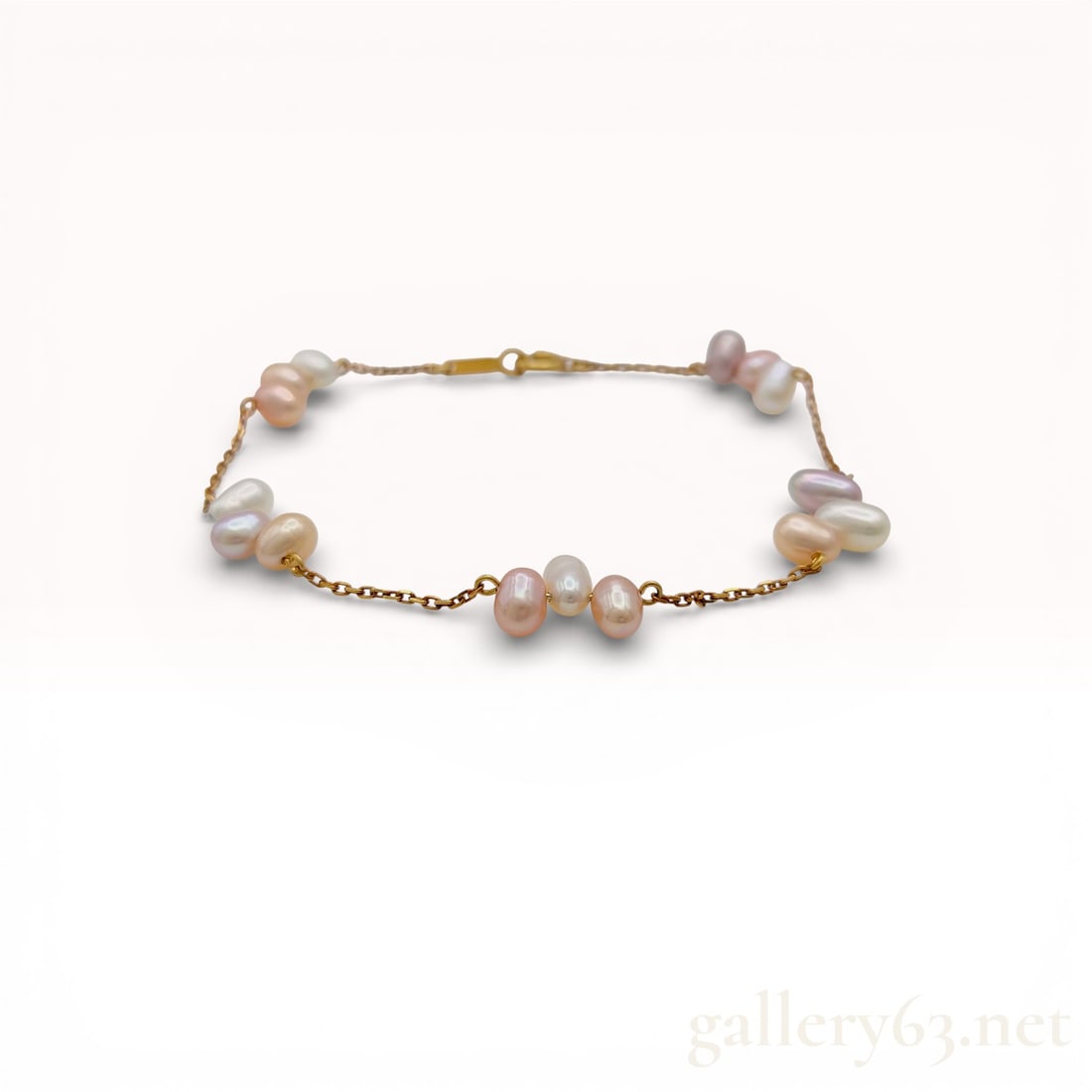18K Yellow Gold 5.6-6.3mm Freshwater Pearl Station Bracelet 6.75": 18K yellow gold bracelet featuring scattered 5.6-6.3mm freshwater pearls arranged in station-style groupings along a fine link chain. Pearls present in soft white to blush tones with irregular baroque