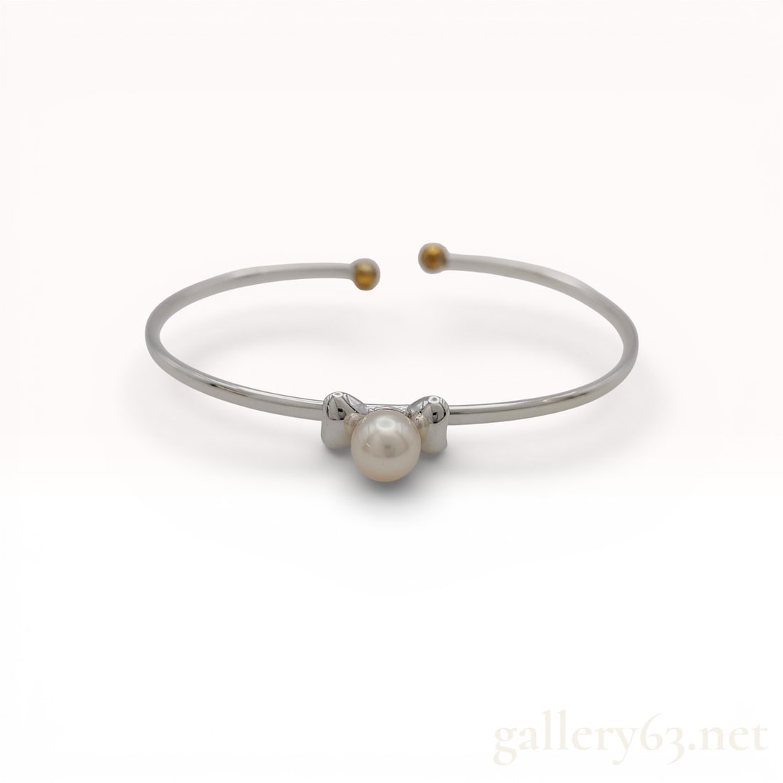 18KYG/925 Two-Tone 7.8mm Pearl Accent Open Bangle Bracelet with Gold Ball Terminals, 7": 925/18k yellow gold bracelet featuring a sleek sterling silver open bangle form with contrasting yellow gold ball terminals at each end. Center design showcasing a single round pearl framed by sculpte