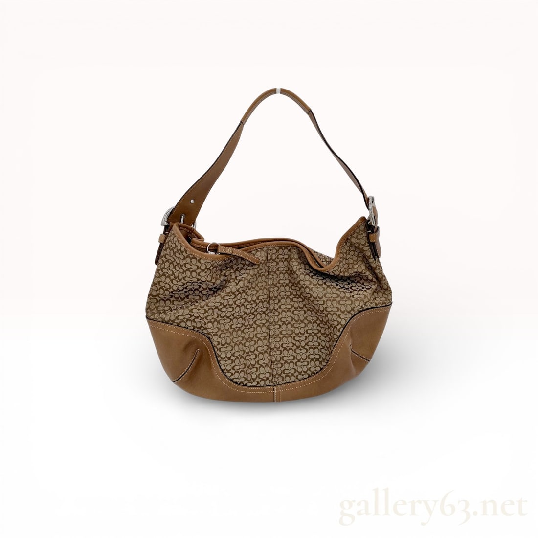 Coach Signature Canvas Mini Shoulder Bag Featuring Brown Leather Trim and Zip-Top Closure: This is a classic Coach signature shoulder silhouette. Coach signature canvas mini shoulder bag featuring a curved hobo-style silhouette in brown logo jacquard. Smooth leather trim accents along the b