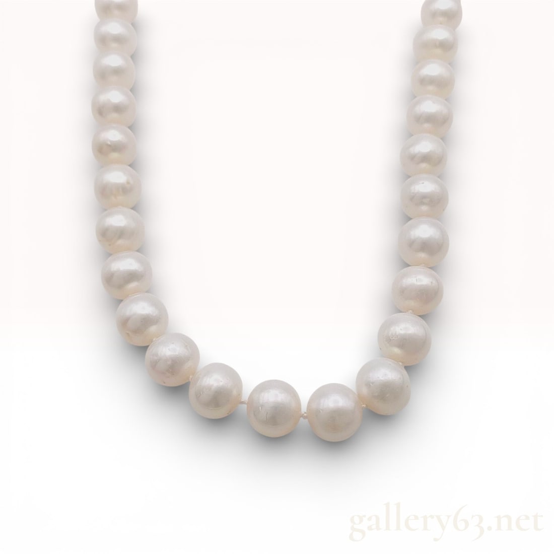 Classic Individually Knotted Strand of Cultured Pearls 8.7-9.3mm with 925 Silver Clasp approx. 20": Strand necklace featuring graduated white pearls displaying a soft cream luster. Design having round pearls measuring approximately 8.7–9.3 mm. Necklace completed with a sterling silver clasp marked
