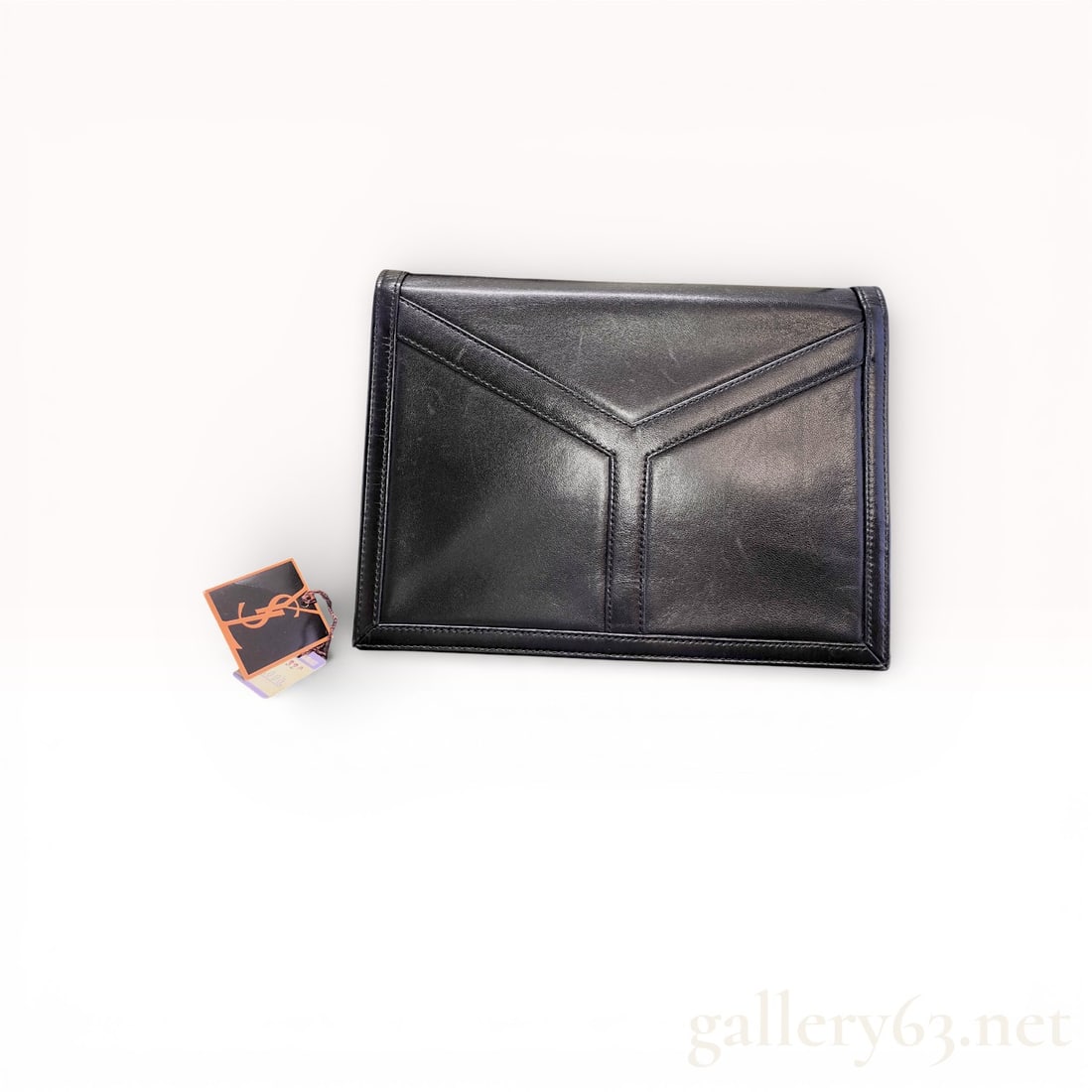Yves Saint Laurent Black Leather Clutch Bag with Box Featuring Geometric Y-Stitch Front Panel: This one is especially nice because it includes the box, dust bag, and tag. Yves Saint Laurent black leather clutch bag featuring a structured rectangular silhouette. Front exterior featuring geometri