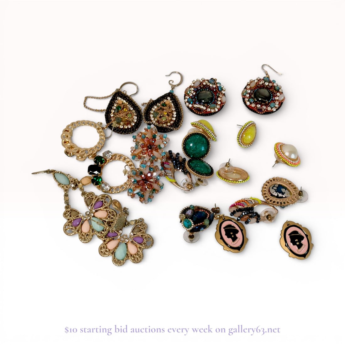 Grouping of Vintage Gold-Tone Earrings: The grouping includes dangling and stud-style earrings with decorative motifs such as florals, abstract forms, and cameo-style profiles. Materials include gold, beads, gemstones, enamel accents, and r