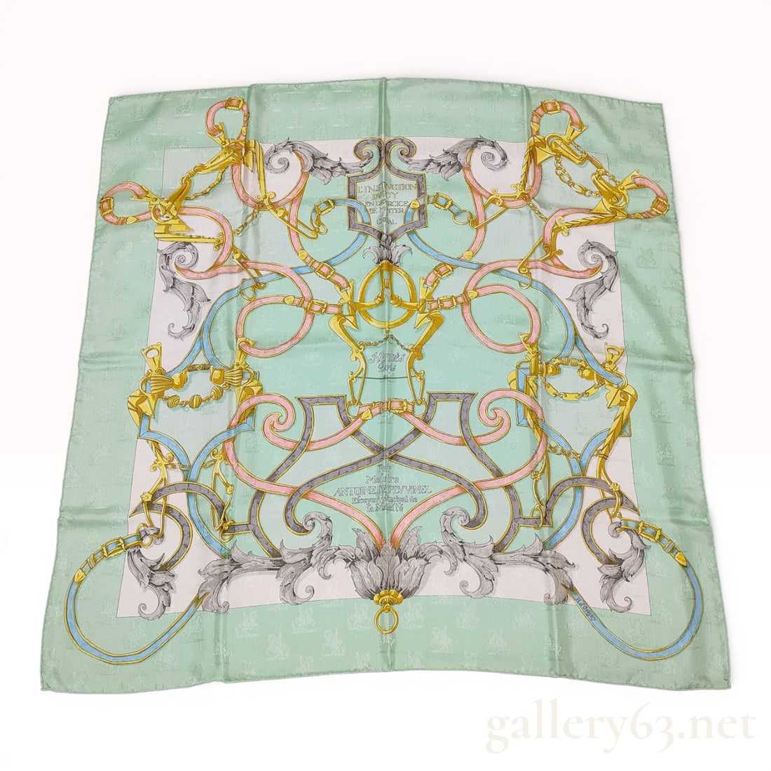 Hermès Carré 90 Silk Scarf with Chain Link Motif in Mint Green and Gold: Hermès Carré 90 silk scarf featuring an intricate chain link and ornamental scroll motif in mint green, gold, gray, and blush tones. Design having a symmetrical composition with layere