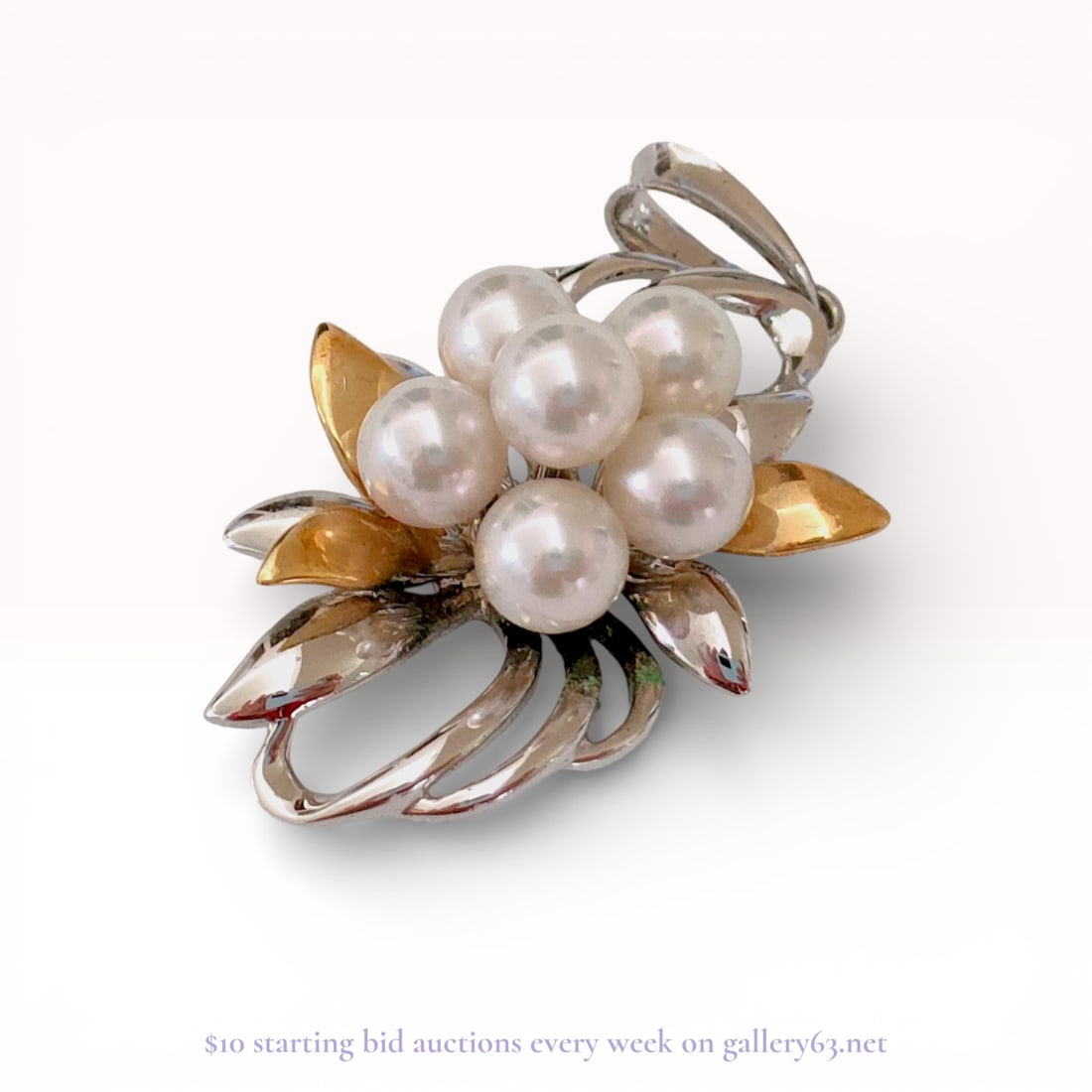 18KYG Pendant With Pearls: Authentic 18KYG floral brooch featuring a central cluster of round pearls arranged in a flower form. The design is executed in mixed sterling silver and 18K yelllow gold, with stylized leaf and scroll