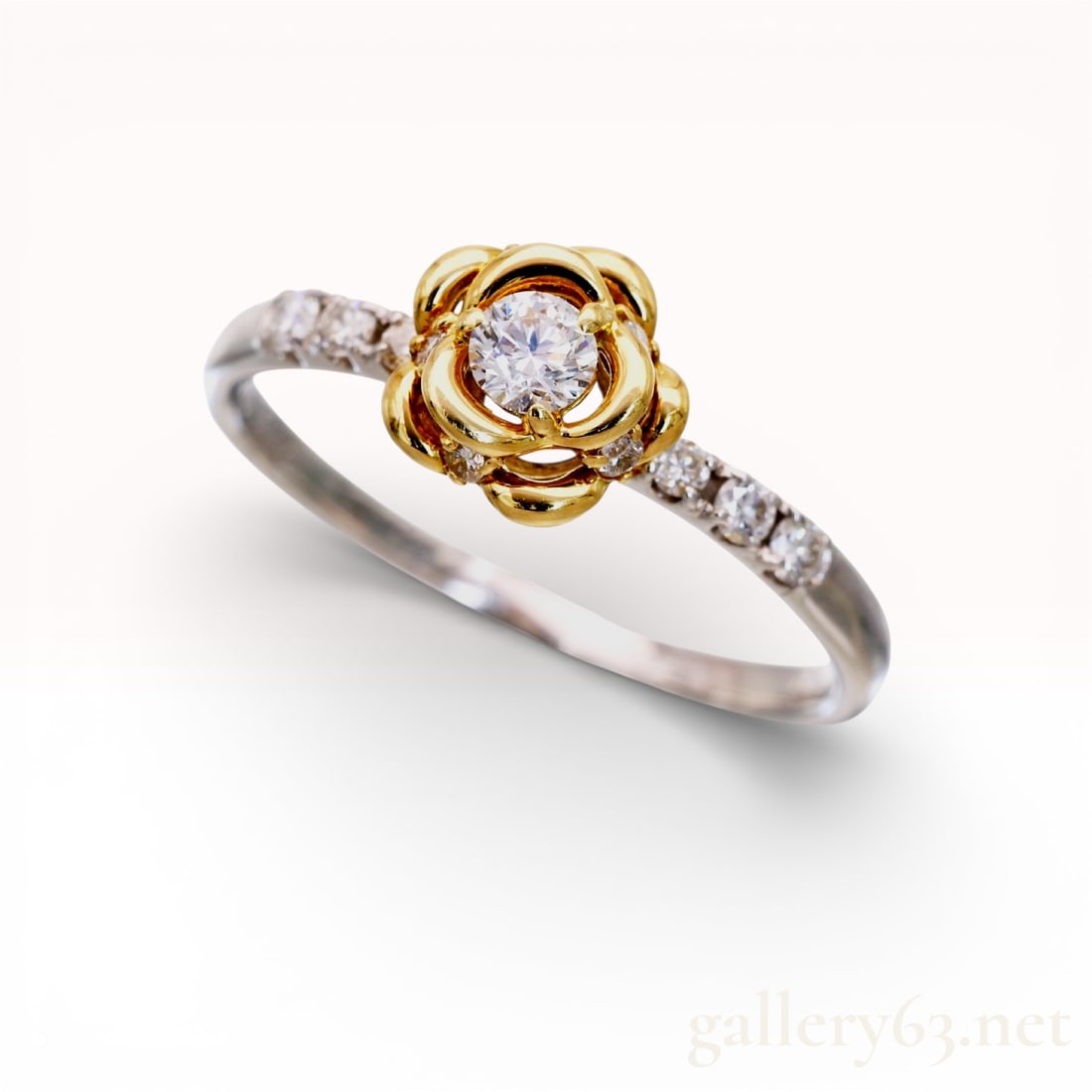 Stunning Platinum and 18k Yellow Gold Diamond Floral Motif Ring, size 6: Platinum and 18k yellow gold ring featuring a natural round brilliant-cut diamond center framed by a sculptural floral-style setting. Band accented with additional round brilliant-cut diamonds along t