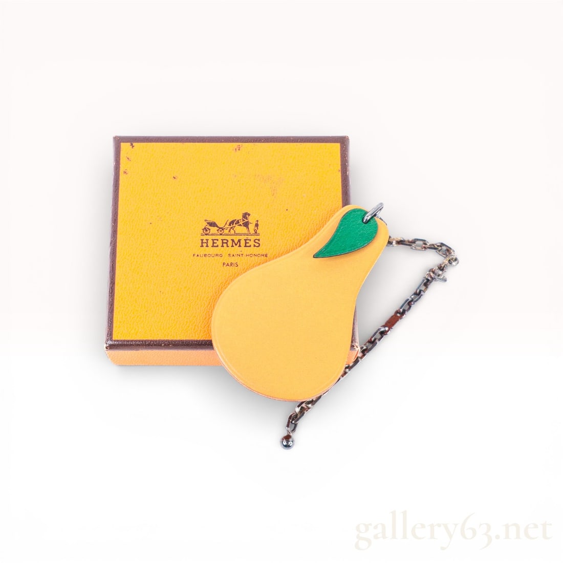 Hermes Pear Fruit Motif Leather Charm with Chain: Authentic Hermes charm crafted from smooth tan leather in a pear fruit motif Attached to an antiqued chain with Hermes H-link detail Playful accessory suitable as a bag charm or key holder