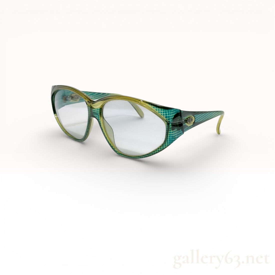 Christian Dior Green Plastic Sunglasses: These Christian Dior sunglasses feature glossy translucent green plastic frames with a slightly upswept, cat-eye inspired silhouette. The front is a soft rounded rectangle shape, and the temples have