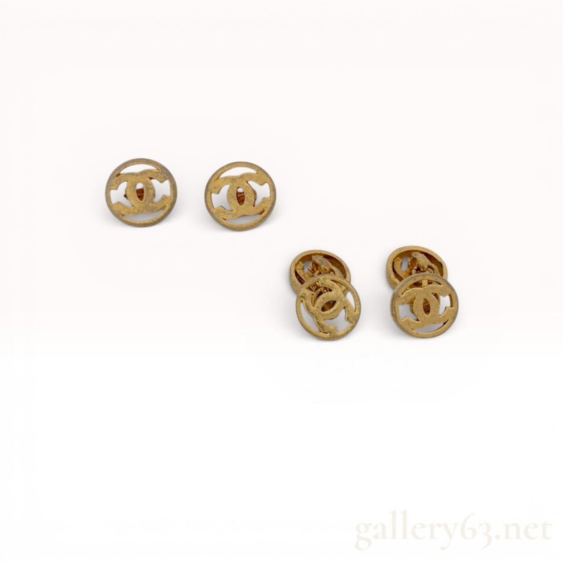 Chanel Gold-Tone Button Cufflinks Set with CC Logo: Authentic Chanel Set featuring multiple gold-tone button cufflinks having openwork CC logo fronts and smooth rounded edges. Backs featuring fixed posts and connecting links. Surfaces featuring light t
