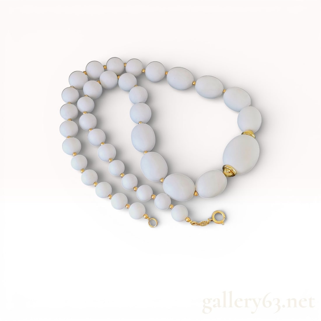 Vintage Christian Dior White Bead Necklace: Authentic Christian Dior White Bead Necklace. Necklace composed of graduated white beads in smooth oval and round shapes. Gold-tone spacers placed between each bead. Decorative gold-tone accent bead n