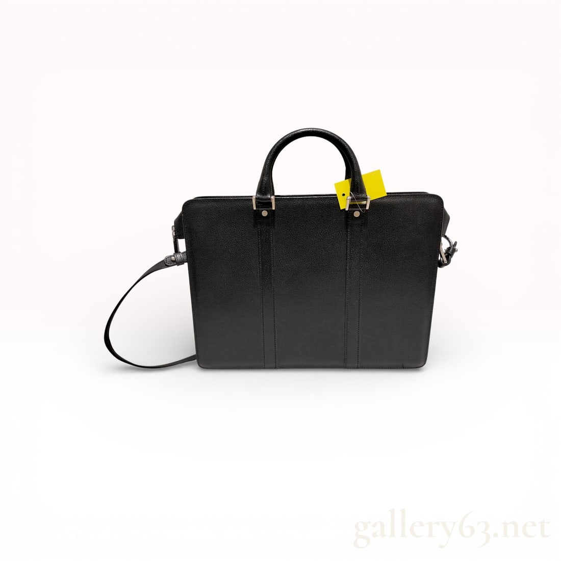 Salvatore Ferragamo Black Leather 2-Way Business Bag: Authentic Salvatore Ferragamo leather business bag having a structured silhouette featuring rolled leather handles, a detachable shoulder strap, and silver-tone hardware. Exterior leather featuring li