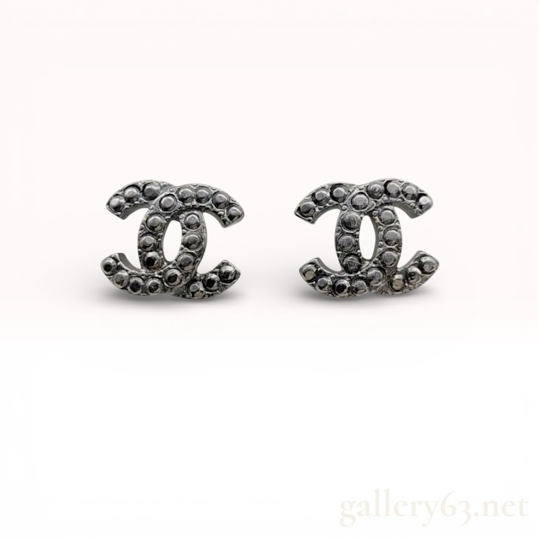 Chanel CC Logo Earrings 2006 Autumn 06A: Authentic Chanel earrings having silver-tone CC silhouettes featuring raised textured detailing. Fronts featuring darkened patina from age and wear. Backs featuring post fittings with 06A hallmark