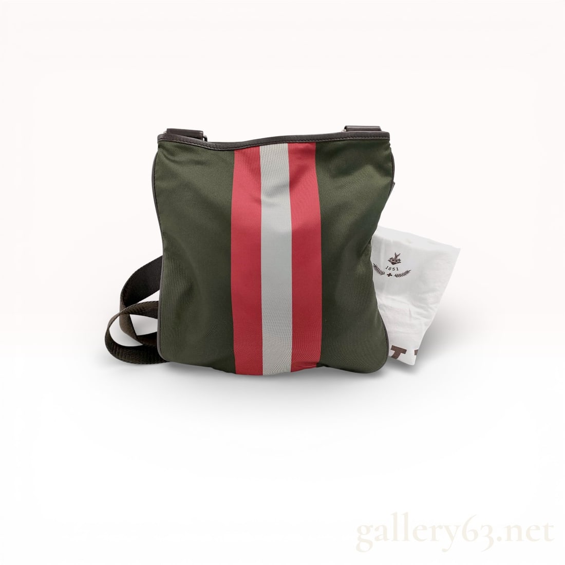 BALLY Canvas Crossbody Bag with Signature Stripe: Bag having dark green canvas body featuring wide vertical stripe panel in red and white at front. Back remaining plain. Top opening set with zipper closure. Interior lined in brown fabric having singl