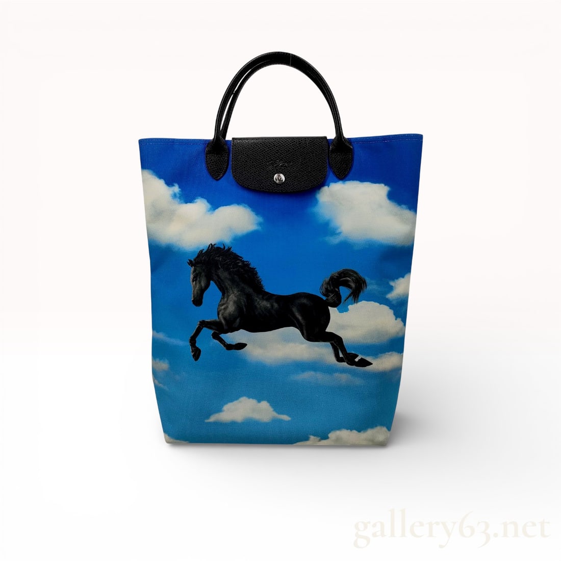 Longchamp Cloud Print Tote Bag with Black Horse Motif: Blue Longchamp tote bag having vertical rectangular form with printed cloud background and large black rearing-horse motif on front. Bag featuring black textured leather top handles and matching leath