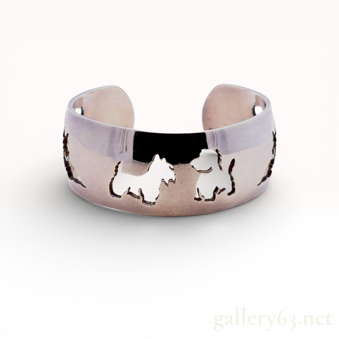Hermes Scottie Dog 925 Sterling Silver Cutout Cuff Bracelet: Authentic Hermes bracelet crafted in polished sterling silver Decorated with whimsical cut-out dog motifs around the band Open cuff style, comfortable and easy to wear Solid sterli