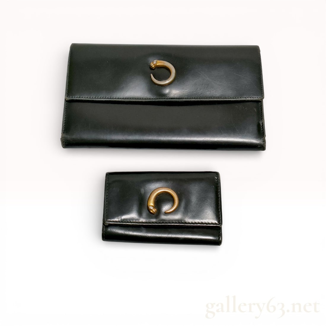 Cartier Panther Wallet Set group of 2: authentic cartier panther wallet set including one long bifold and one compact wallet, both crafted in black leather with gold-tone panther head hardware. the larger wallet features multiple card