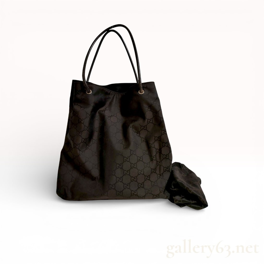 Gucci Black GG Nylon Tote with Leather Handles: Authentic Gucci Black GG Nylon Tote with Leather Handles Tote bag having a black GG-pattern nylon exterior featuring a soft, unstructured silhouette. Handles featuring slim black leather