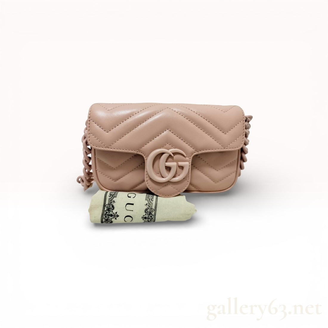 Gucci GG Marmont shoulder bag in light blush pink matelassé leather: Gucci GG Marmont shoulder bag in light blush pink matelassé leather with chevron stitching and matching pink interlocking GG logo on the front flap; smooth leather finish with minor creasing; matte p