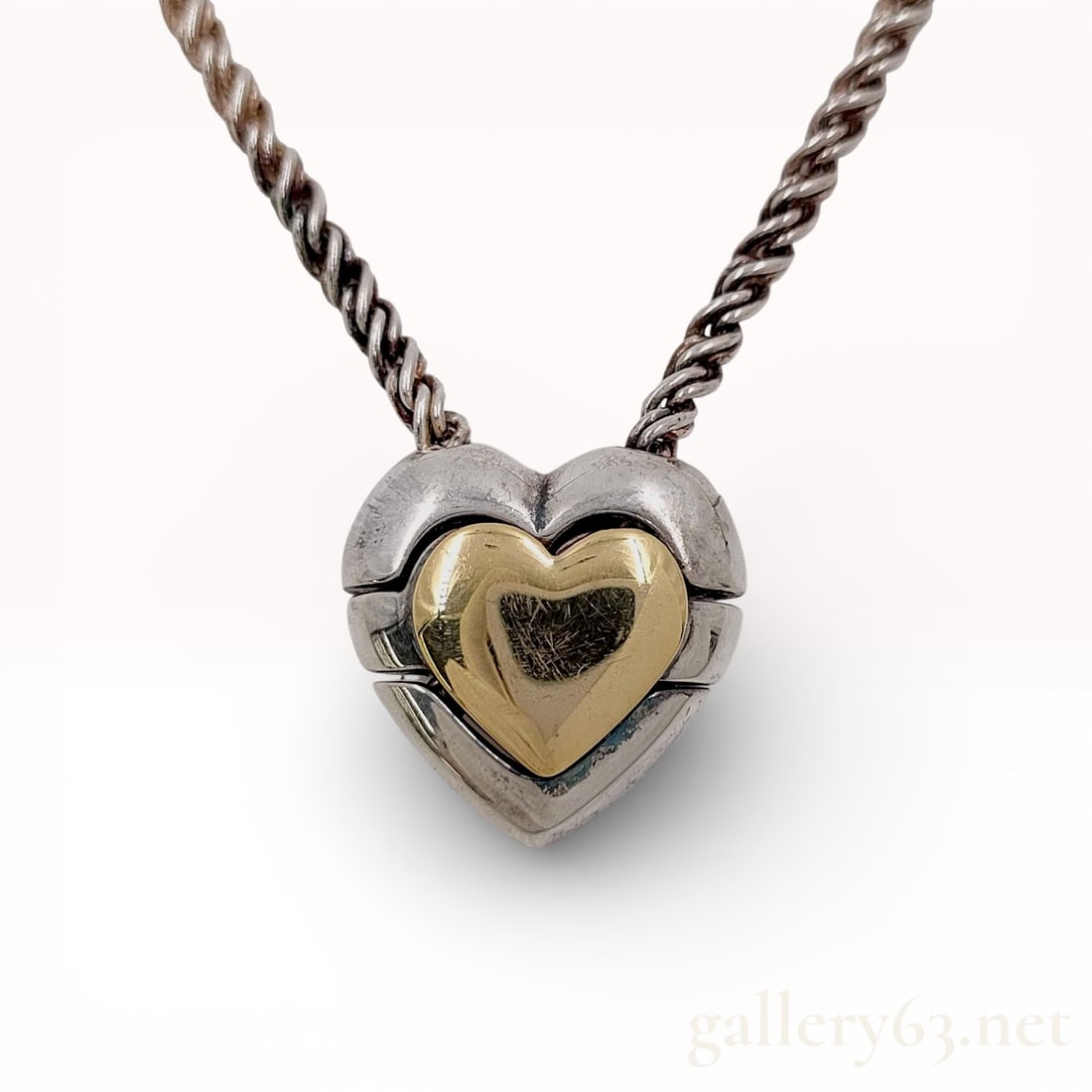 18K Gold & 925 Tiffany & Co. Puzzle Heart Necklace 16": Authentic Tiffany & Co. Puzzle Heart Necklace in Sterling Silver and 18k Gold. Necklace featuring a heart pendant formed in sterling silver with an 18k yellow gold heart inset at the center.