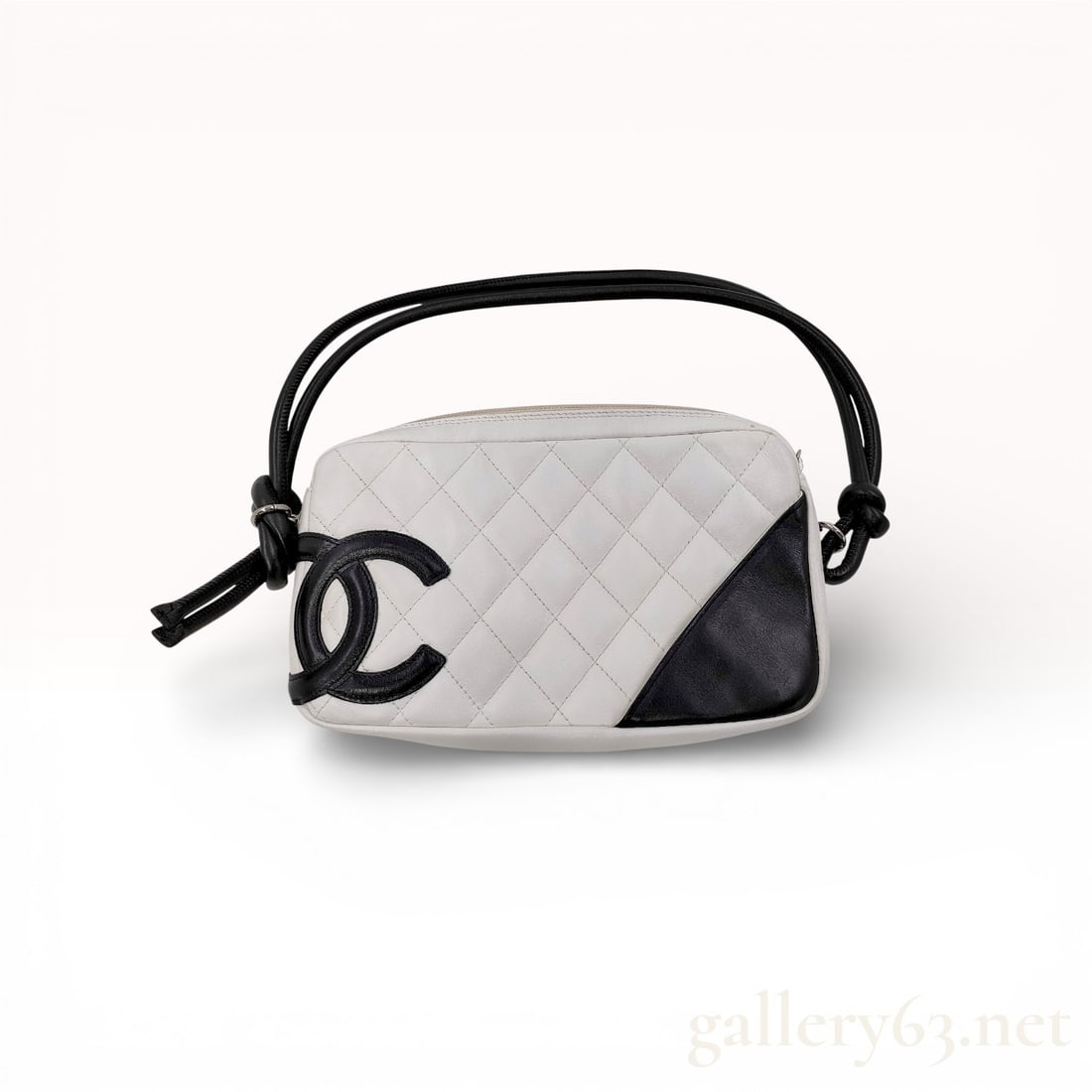 Chanel Cambon Line Lambskin Black and White Quilted Bag: Authentic Chanel Cambon handbag crafted from quilted white lambskin leather with black corner accent and oversized black CC logo appliqué. Features a zip-top closure and black knotted leather strap.