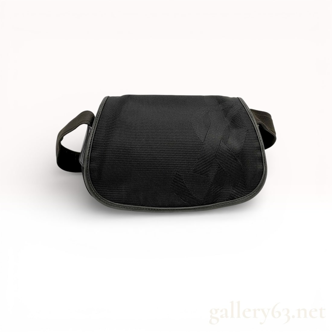 Yves Saint Laurent Nylon and Leather Shoulder Bag: Authentic Yves Saint Laurent Nylon and Leather Shoulder Bag. Shoulder bag having a black nylon body with tonal YSL patterning and leather trim along the edges. Featuring a flap closure and an adjustab