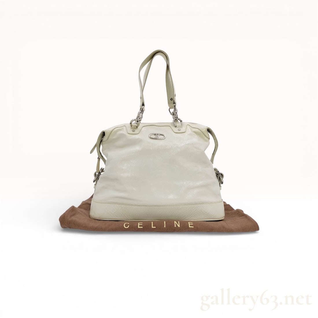 Celine White Macadam Leather Handbag: Celine handbag having a soft rectangular body with rounded corners and double top handles. Featuring glossy white leather exterior with subtle grain texture and tonal stitching. Set with silver-tone h