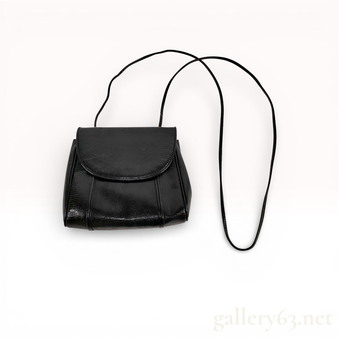 Yves Saint Laurent Lizard Skin Black Shoulder Bag: YSL Yves Saint Laurent Vintage small shoulder bag in black leather with lizard skin leather on flap and trim. Rounded flap front with snap closure. Compact structured body with soft side gussets. Long