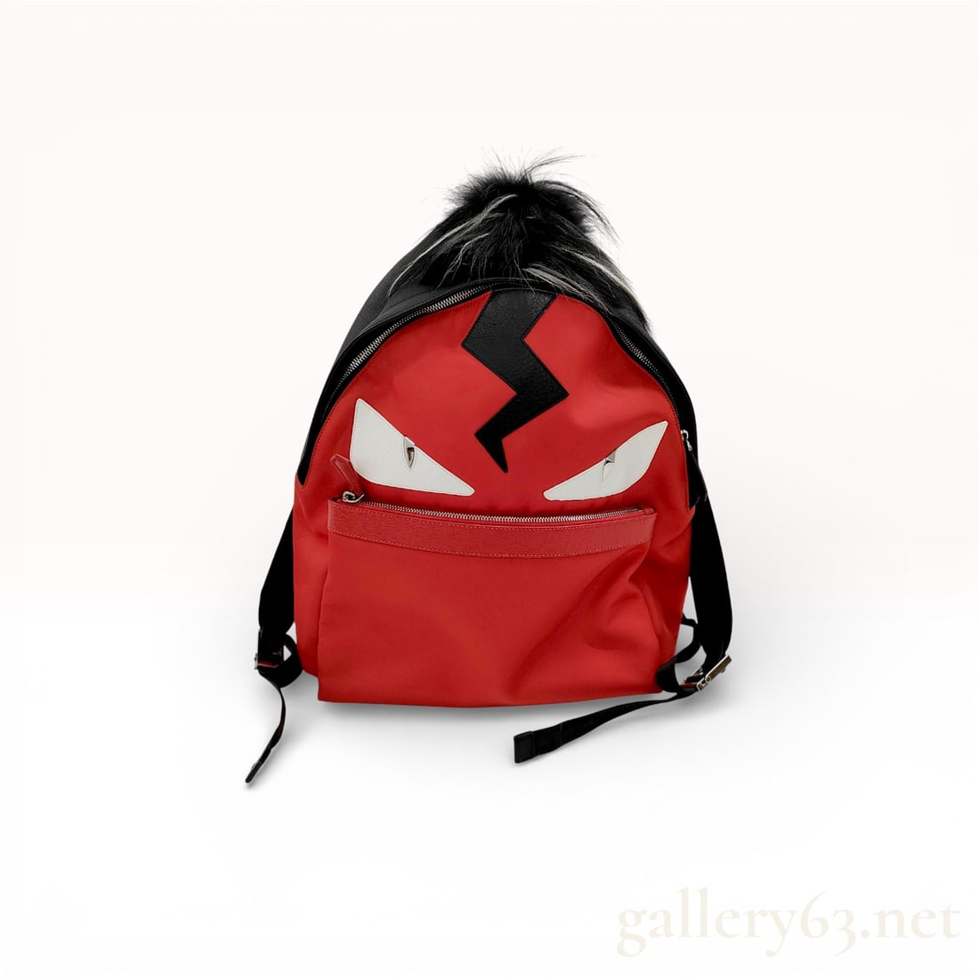 Fendi Red Nylon Monster Backpack with Fur Detail: Fendi backpack having a rounded top shape with zip closure and front zip pocket. Featuring red nylon exterior accented with the signature Monster face design, including white leather eyes and black li