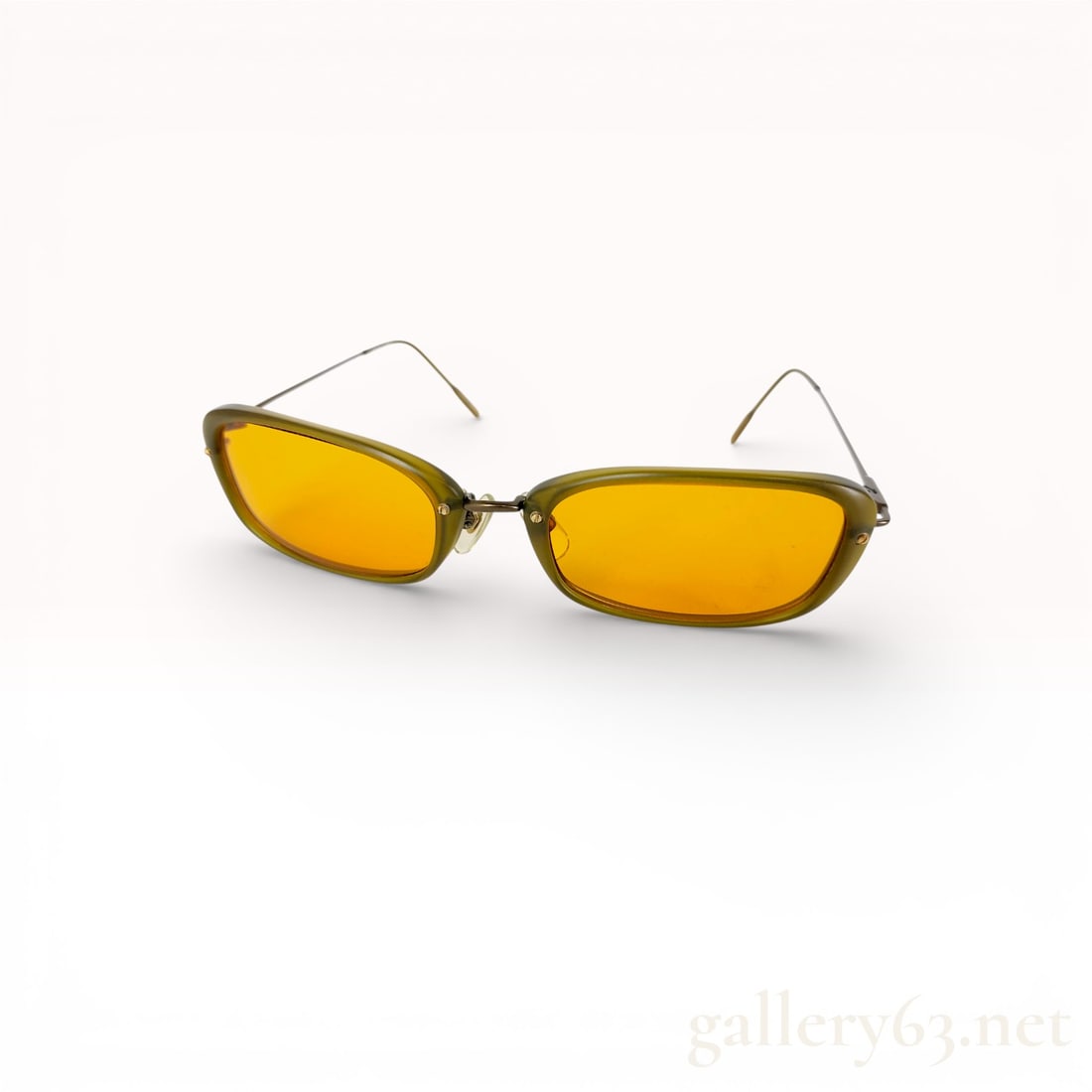 Issey Miyake IM Product Olive Frame Sunglasses with Amber Lenses: issey miyake sunglasses, authentic. rectangular lenses in amber-yellow tone set in translucent olive green plastic frame. thin silver-tone metal arms with matching olive plastic ear tips. bridge and h